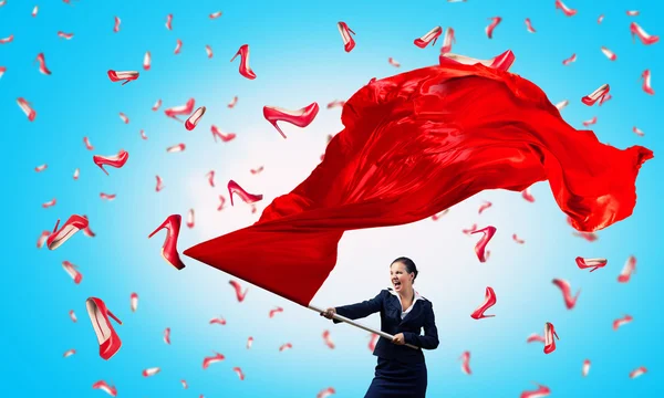 Woman waving red flag . Mixed media — Stock Photo, Image