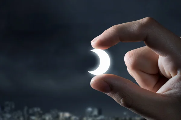 Moon between fingers . Mixed media — Stock Photo, Image