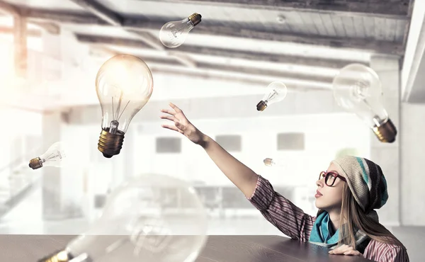 Hipster girl looking from under table — Stock Photo, Image