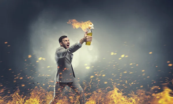 Businessman throwing petrol bomb . Mixed media — Stock Photo, Image