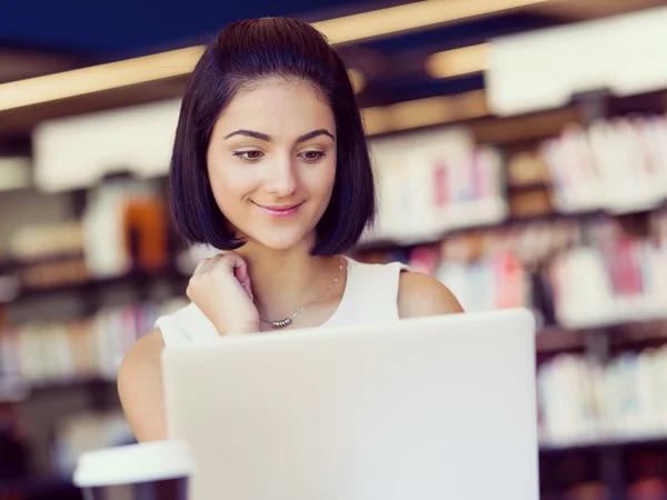 Happy female student at the library — Stock Photo, Image