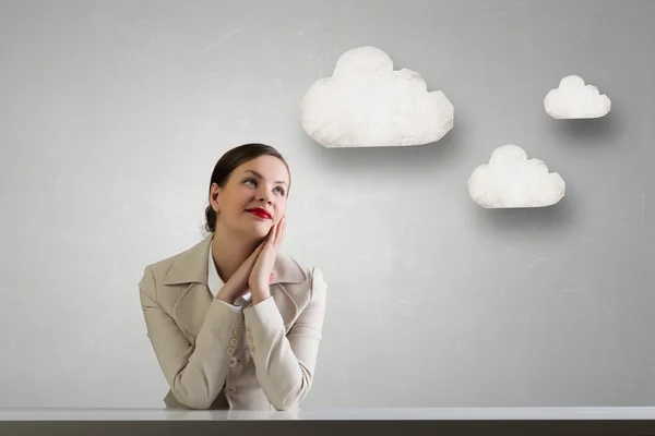 Businesswoman sitting at desk .  Mixed media — Stock Photo, Image