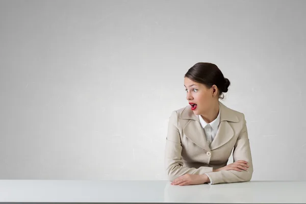 Businesswoman sitting at desk  . Mixed media — Stock Photo, Image