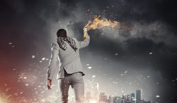 Businessman throwing petrol bomb . Mixed media — Stock Photo, Image