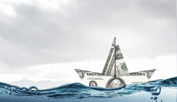 Dollar paper boat . Mixed media — Stock Photo, Image