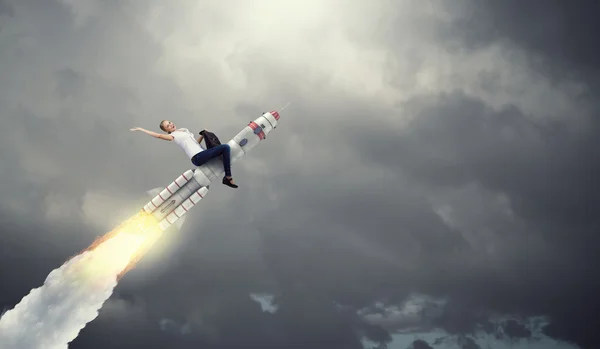 Woman riding missile . Mixed media — Stock Photo, Image