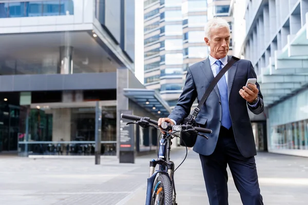 Successful businessman riding bicycle — Stock Photo, Image