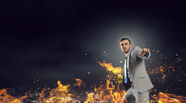 Businessman throwing petrol bomb . Mixed media — Stock Photo, Image