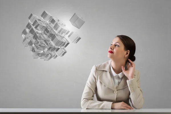 Businesswoman sitting at desk . Mixed media — Stock Photo, Image