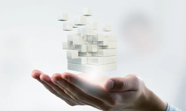 Cube in male hand . Mixed media — Stock Photo, Image
