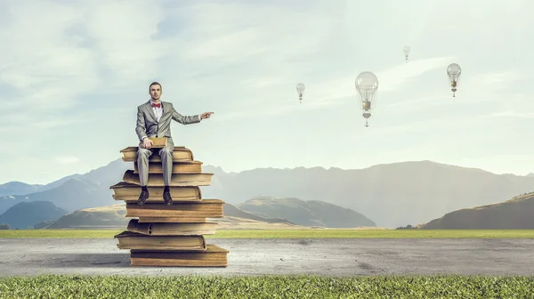 Businessman with old book . Mixed media — Stock Photo, Image