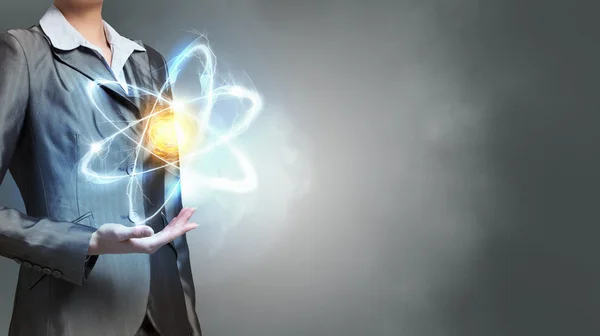 Atom molecule in hands . Mixed media — Stock Photo, Image