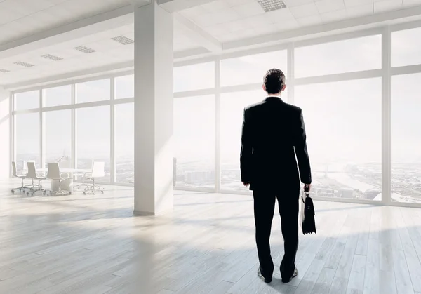 Businessman in office  . Mixed media — Stock Photo, Image