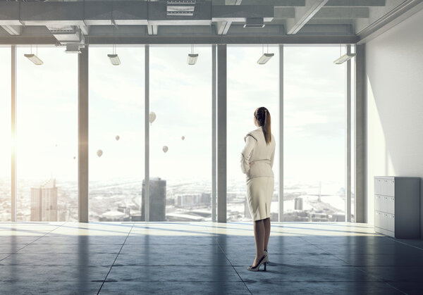 Businesswoman in modern office interior  . Mixed media