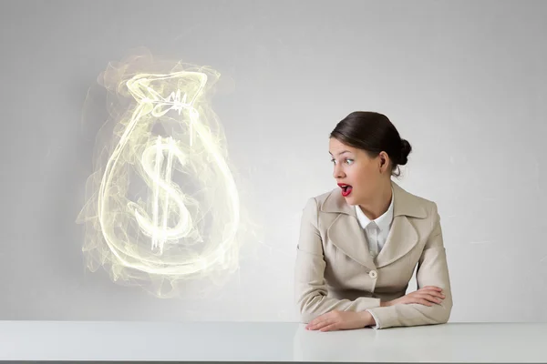 Businesswoman sitting at desk . Mixed media — Stock Photo, Image