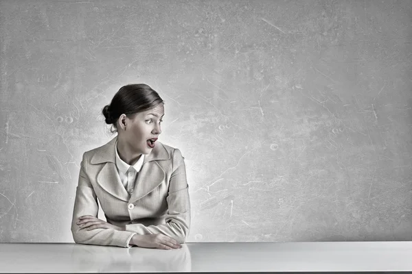 Businesswoman sitting at desk . Mixed media — Stock Photo, Image