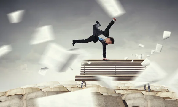 Young businessman breakdancer . Mixed media — Stock Photo, Image