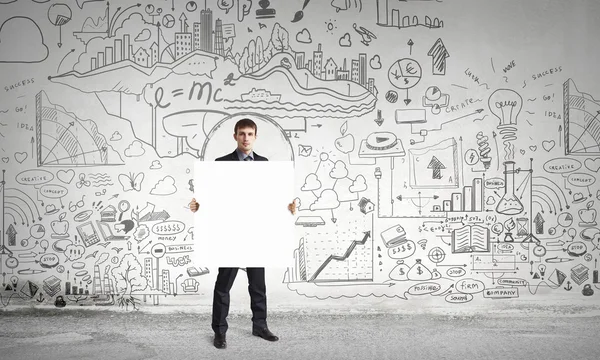 Businessman with blank banner . Mixed media — Stock Photo, Image