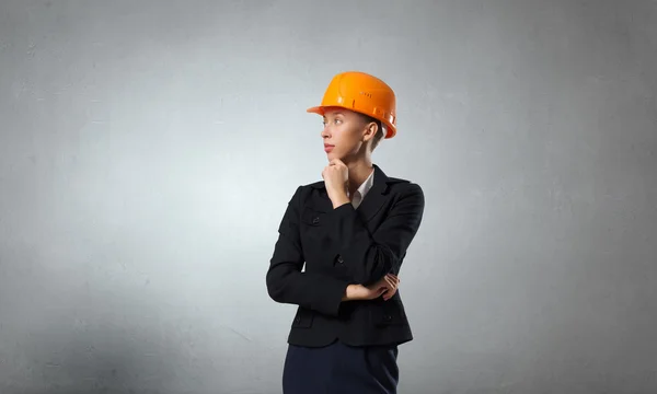 Thoughtful engineer woman . Mixed media — Stock Photo, Image