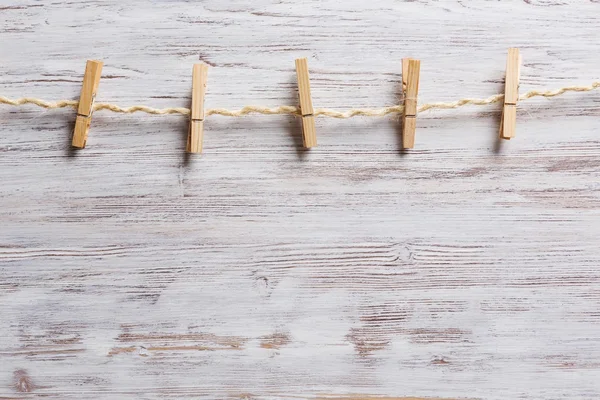 Wooden clothespins on a rope — Stock Photo, Image