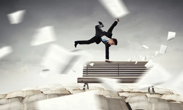 Young businessman breakdancer . Mixed media — Stock Photo, Image