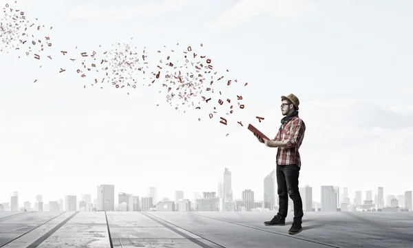 Young man with book . Mixed media — Stock Photo, Image