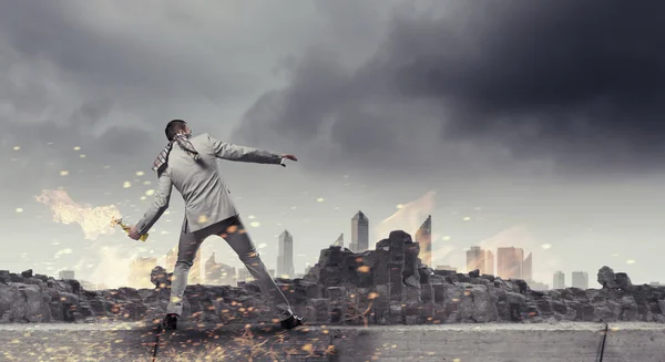 Businessman throwing petrol bomb . Mixed media — Stock Photo, Image