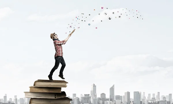 Hipster guy with book . Mixed media — Stock Photo, Image