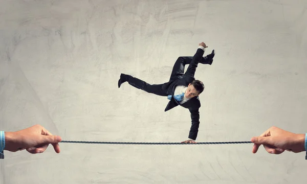 Young businessman breakdancer . Mixed media — Stock Photo, Image