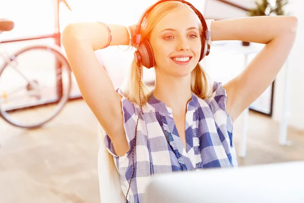 Young woman working in office with headphones — Stock Photo, Image