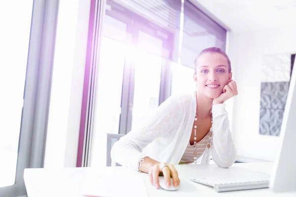 Attractive office worker sitting at desk — Stock Photo, Image