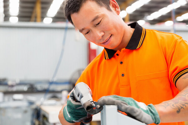 Asian worker in production plant on the factory floor