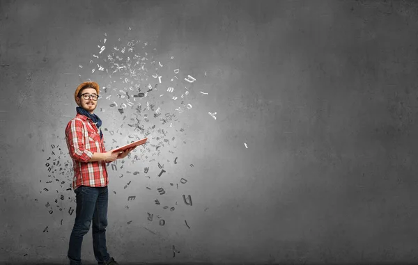 Hipster guy with book in hands . Mixed media — Stock Photo, Image