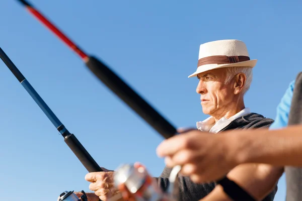 Senior mens vissen op zee zijkant — Stockfoto