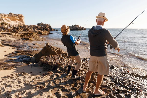 Senior man fishing with his grandson — Stock Photo, Image