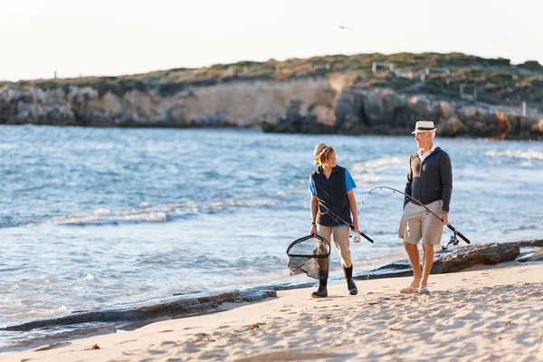 Senior man fishing with his grandson — Stock Photo, Image