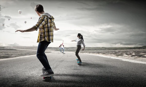 Teenagers ride skateboards . Mixed media — Stock Photo, Image