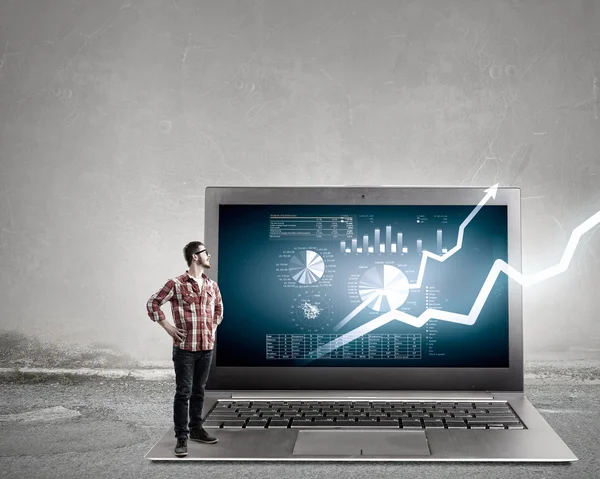 Guy and big laptop . Mixed media — Stock Photo, Image