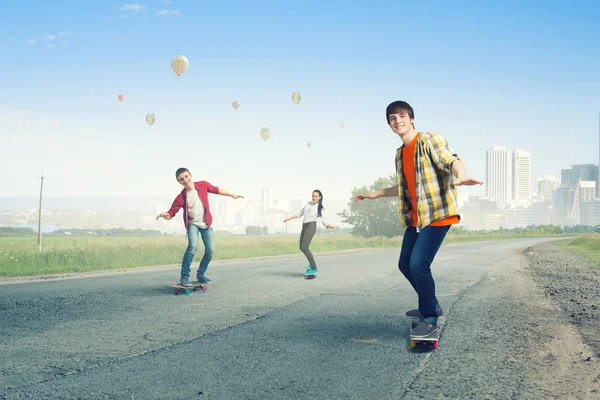 Teenagers ride skateboards . Mixed media — Stock Photo, Image