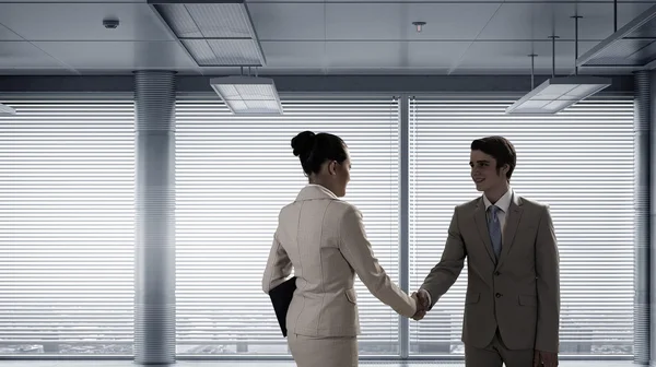 Business partners handshake . Mixed media — Stock Photo, Image