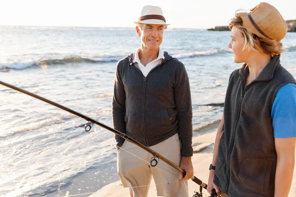 Senior man fishing with his grandson — Stock Photo, Image