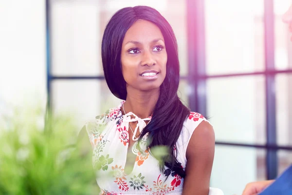 Portret van Afro-Amerikaanse kantoor werknemer zitten in offfice glimlachend — Stockfoto