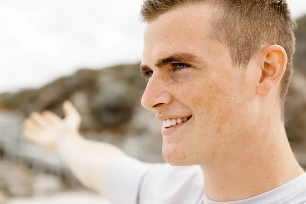 Young man in sport wear with outstretched arms — Stock Photo, Image