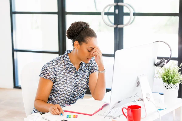 Portrait of tired afro-american office worker sitting in offfice — Stock Photo, Image