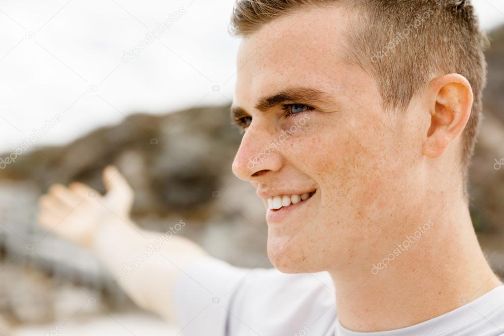 Young man in sport wear with outstretched arms