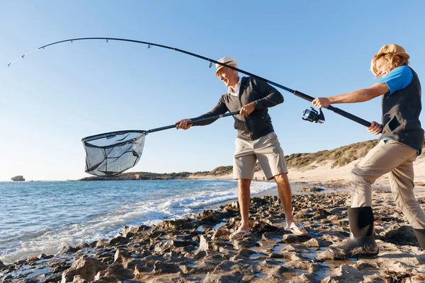 Senior man vissen met zijn kleinzoon — Stockfoto