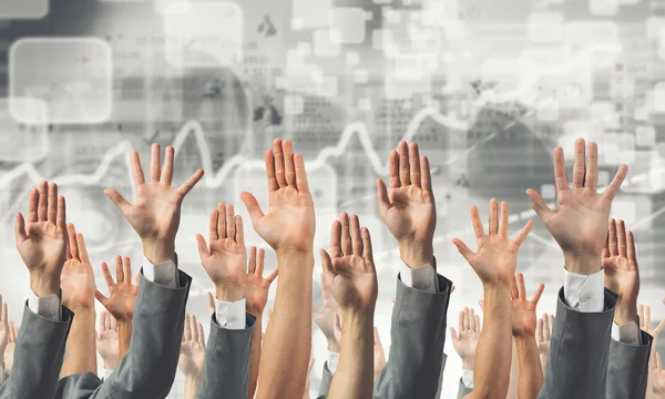 Grupp människor med upphöjda händer. Mixed media — Stockfoto
