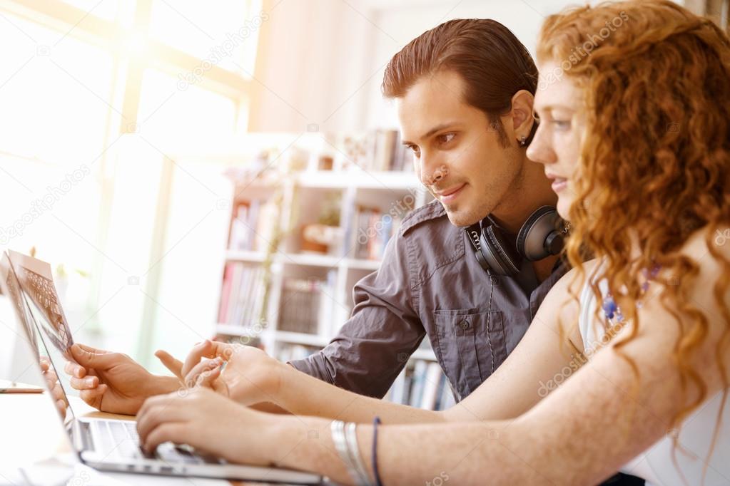 Two young people in office