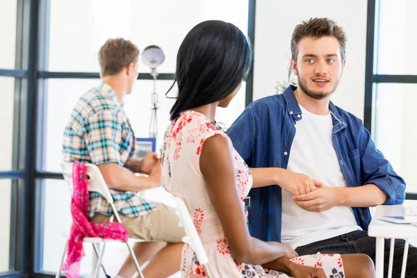 Young workers talking in office — Stock Photo, Image