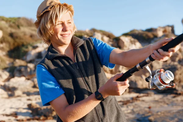 Teenage boy fishing at sea — Stock Photo, Image